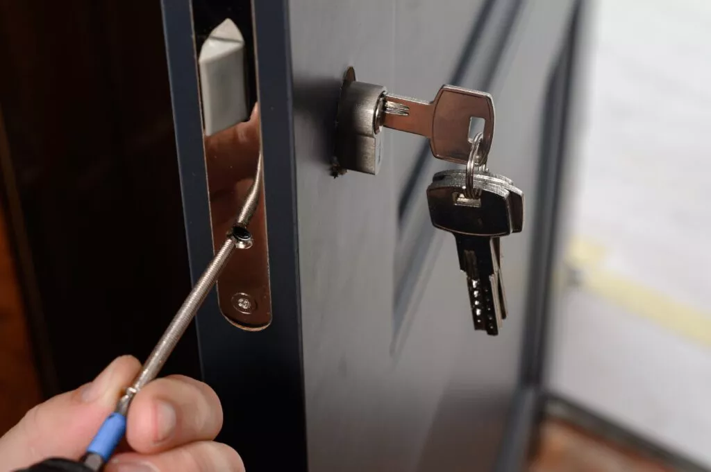 Locksmith working on a door lock — All Hours NI Belfast