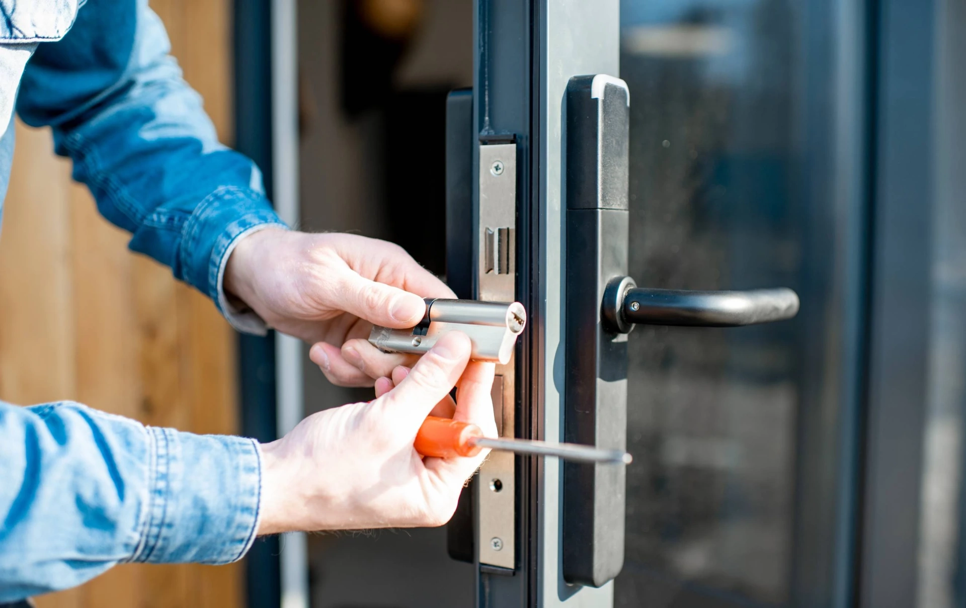 Locksmith replacing a door cylinder — emergency lockout Belfast