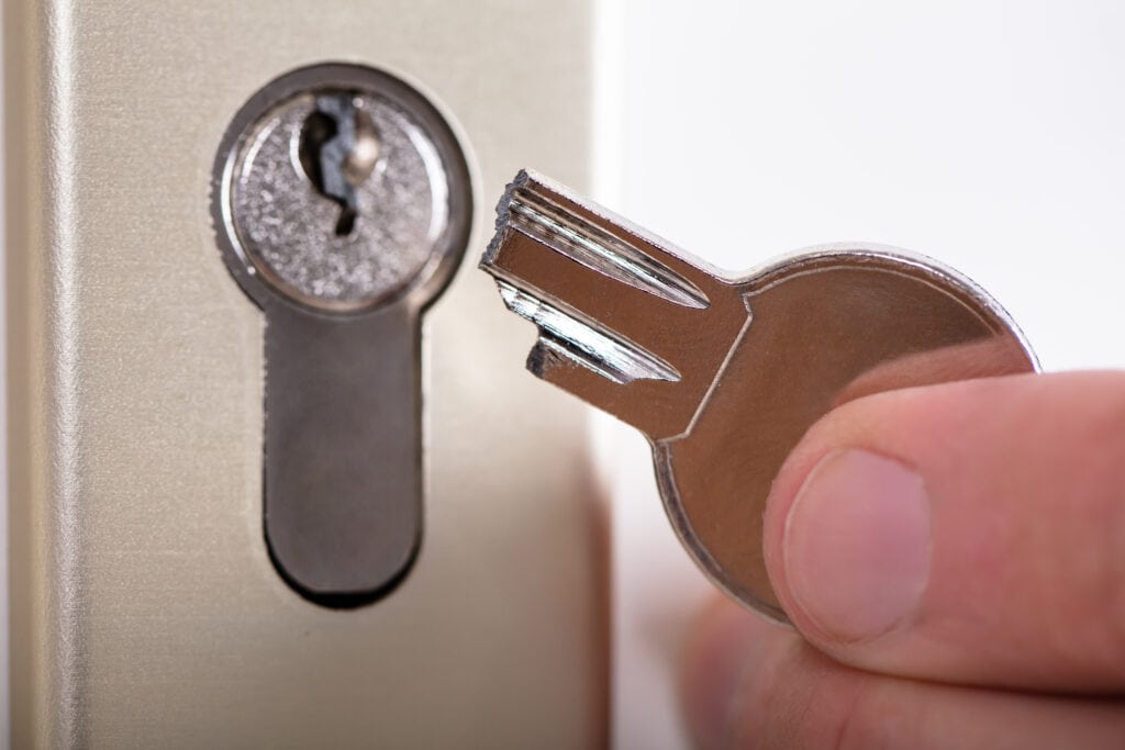 Broken key being held next to a euro cylinder lock - a common lock repair job in Belfast